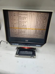Vintage microfilm reader with document displayed.