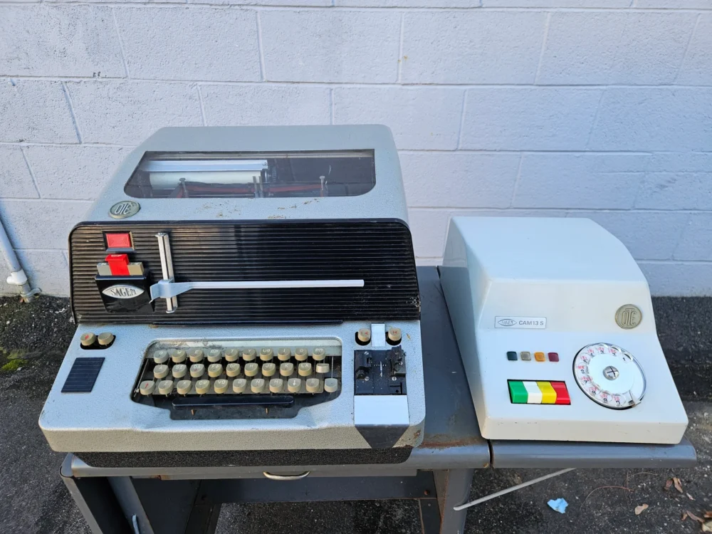 Vintage teletype machine with control panel.