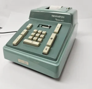 Vintage Remington calculator with keypad and paper.
