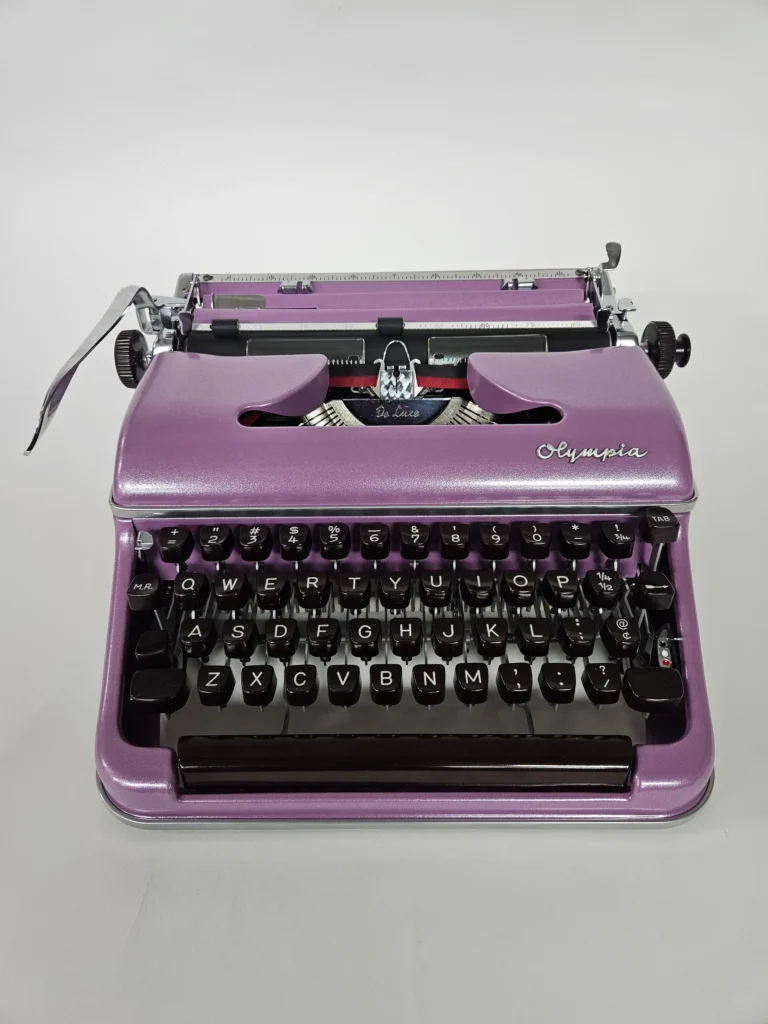 Purple vintage Olympia typewriter on display.