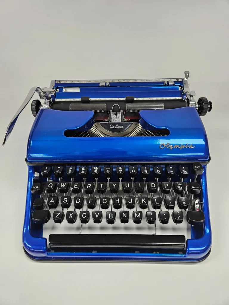 Blue vintage typewriter with black keys.